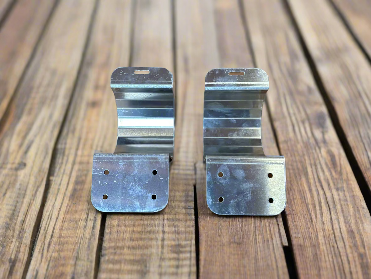 Two metal brackets on a wood deck